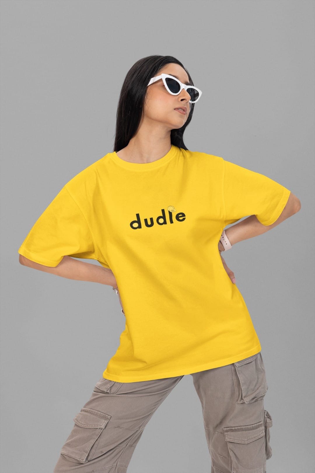 Model wearing a yellow Dudle oversized T-shirt with cargo trousers